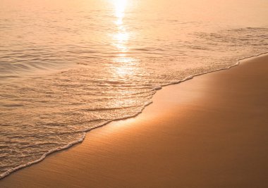 Water and sand at the beach in sunset time