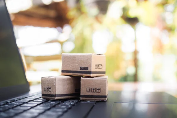 Boxes on a laptop keyboard. Concepts about online shopping that offers home delivery