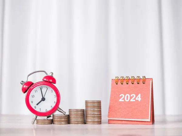 Study goals, 2024 Desk calendar, Red alarm on stack of coins. The concept of saving money and manage time for education, student loan, scholarship, tuition fees in New Year 2024