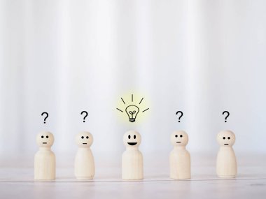 Wooden business figure with light bulb and question mark for leadership, creative, idea, innovation concept.