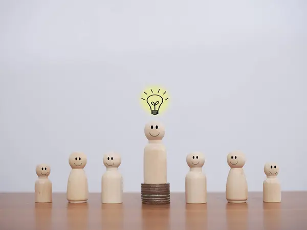 Wooden business figure with light bulb for leadership, creative, idea, innovation concept.