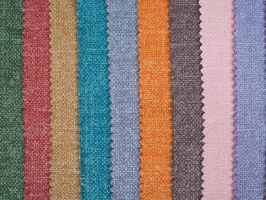 Renkli arka plan, renkli kumaş yığını. Sessiz renkli kumaş arkaplanının tam çerçeve görüntüsü