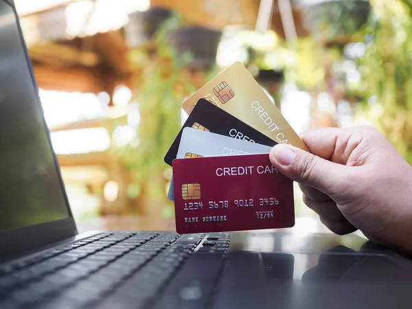 Woman hand holding several credit cards. The concept of Convenience in the world of technology and the internet, Online shopping, banking transaction, banking online and payment