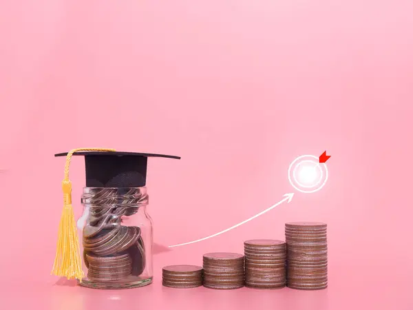 stock image Glass bottle with graduation hat and Stack of coins with arrow rising icons. The concept of saving money for education, student loan, scholarship, tuition fees