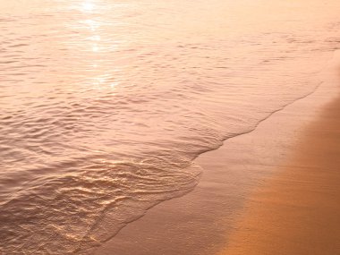 Water and sand at the beach in sunset time