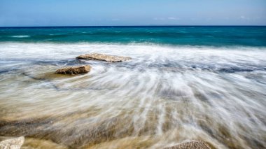 Rocky beach washed by the waves of the Mediterranean sea
