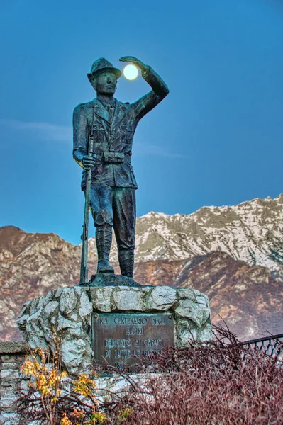 Statue of Alpine soldier holding back the moon with his hand