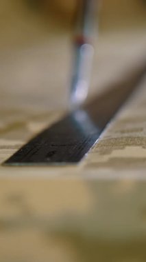 sewing. close-up. tailor, dress cutter draws a pattern on khaki fabric, or camouflage fabric. Sewing workshop. sewing of camouflage military clothes.