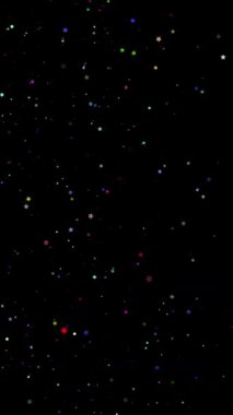 Soyut büyülü arkaplan. Parıldayan, parlak renkli parçacıklar yıldız formunda siyah arkaplana düşüyorlar. Uçan, yanıp sönen yıldızlar parıldıyor. .