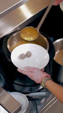 Açık büfe restoranı. Kendi kendine hizmet veren kafeterya. Yakın plan. Garson, koruyucu eldivenlerle müşteriye sıcak çorba dolduruyor. Yemek pişirmek. sağlıklı gıda.