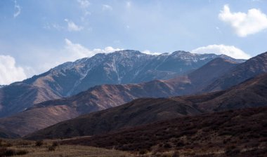 Misty autumn mountain landscape in the morning. Beautiful natural landscapes. View of the misty mountain slopes in the distance. Morning foggy hills. Travel background.
