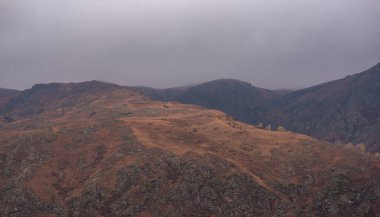 Amazingly beautiful autumn landscapes of a mountainous area located in northern China. Rainy landscape with clouds on top of mountains. Beautiful non-tourist routes. Exploring new places.