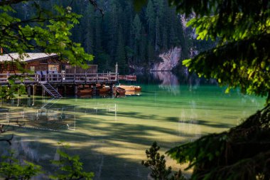 Lake surrounded by the mountains of the Italian alps. Fabulous views, magnificent mountains and lake. Free space for inscription text poster on backdrop nature Lake Braies emerald clear water.