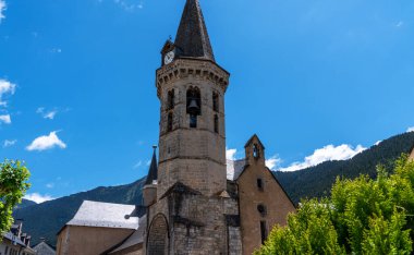 Aran Vadisi 'ndeki Vielha kasabası, Lleida, Katalonya, İspanya. Tapınak şehrin merkezinde, parlak mavi bir gökyüzüne karşı. Bir dağ kasabasındaki şehir manzarası.