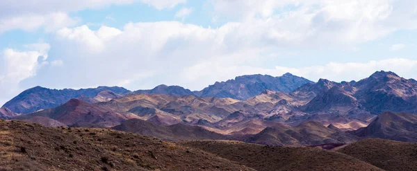 stock image Unusual mountains ridge. Layers of mountains, their shades and formations, accentuated by the light.