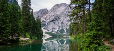İtalyan Alpleri 'ndeki etkileyici güzellikteki peri masalı gölü. Nefes kesici bir manzara. Alplerdeki güzel dağ manzarasının panoramik manzarası kristal suyla Braies Gölü.