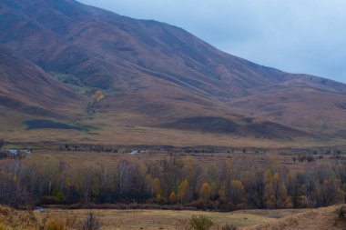 Amazingly beautiful autumn landscapes of a mountainous area located in northern China. Rainy landscape with clouds on top of mountains. Beautiful non-tourist routes. Exploring new places.