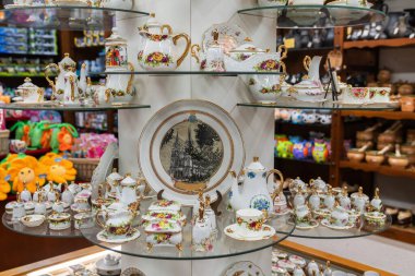 A beautifully arranged display inside a souvenir shop. The shop has colorful stuffed toys and various other items on the shelves in the background. clipart