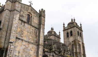 Porto 'nun görkemli Katedrali gri bir gökyüzüne, tarihi taş cephelerine ve ikiz kulelerine karşı durmaktadır..
