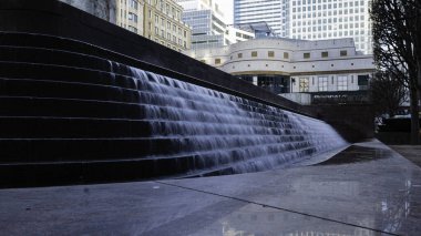 London - 01 26 2022: Cascade fountain and Cabot Square in the background