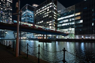 London - 01 26 2022: View of South Dock with Heron Quays Bridge and DLR stop