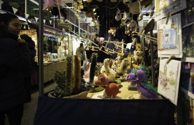 London - 02 27 2022: Woman at Covent Garden market in front of soft toy stalls