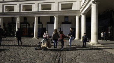 London - 02 27 2022: Mums and sons playing in Covent Garden Square