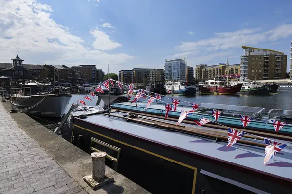 stock image London - 06 04 2022: Houseboat with Union Jack moored at the marina in Limehouse Basin