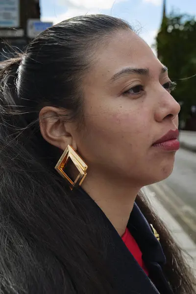 stock image London - 06 11 2022: Young woman looks into the distance