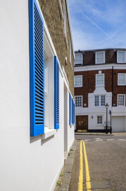 London - 06 16 2022: Blue shutters on white wall in Rutland St clipart