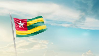Togo waving flag in beautiful sky.
