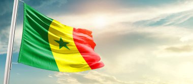 Senegal waving flag in beautiful sky with sun