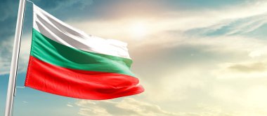 Burkina Faso waving flag in beautiful sky with sun