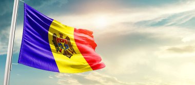 Moldova waving flag in beautiful sky with sun
