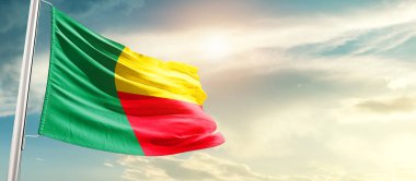 Benin waving flag in beautiful sky with sun