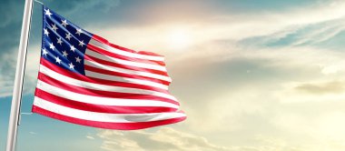  United States waving flag in beautiful sky with sun