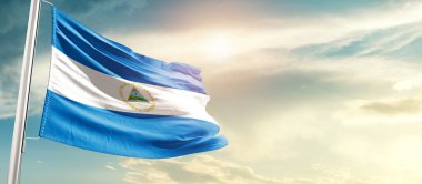 Nicaragua waving flag in beautiful sky with sun