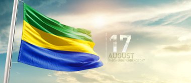 Gabon waving flag in beautiful sky with sun