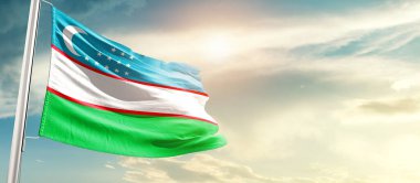Uzbekistan waving flag in beautiful sky with sun