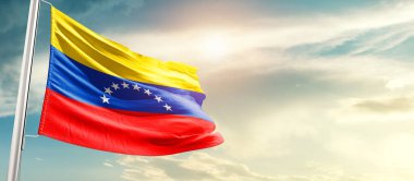 Venezuela waving flag in beautiful sky with sun