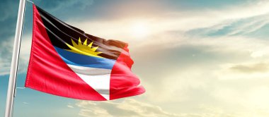 antigua and barbuda waving flag in beautiful sky with sun
