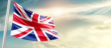 United Kingdom waving flag in beautiful sky with sun