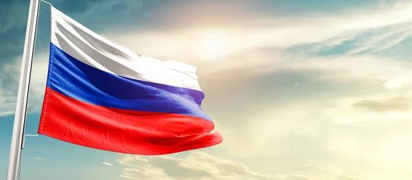 Russia waving flag in beautiful sky with sun