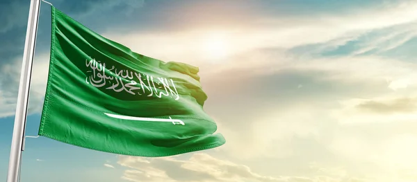 Saudi Arabia waving flag in beautiful sky with sun