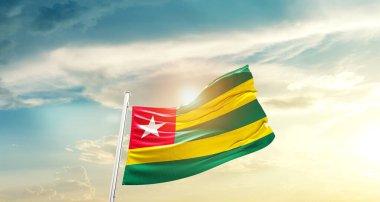 Togo waving flag in beautiful sky with sun