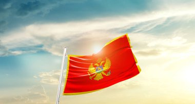 Montenegro waving flag in beautiful sky with sun