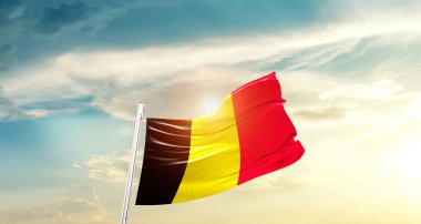 Belgium waving flag in beautiful sky with sun