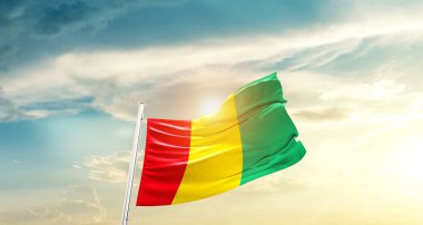 Guinea waving flag in beautiful sky with sun