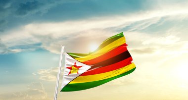 Zimbabwe waving flag in beautiful sky with sun