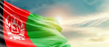 Afghanistan waving flag in beautiful sky with sun